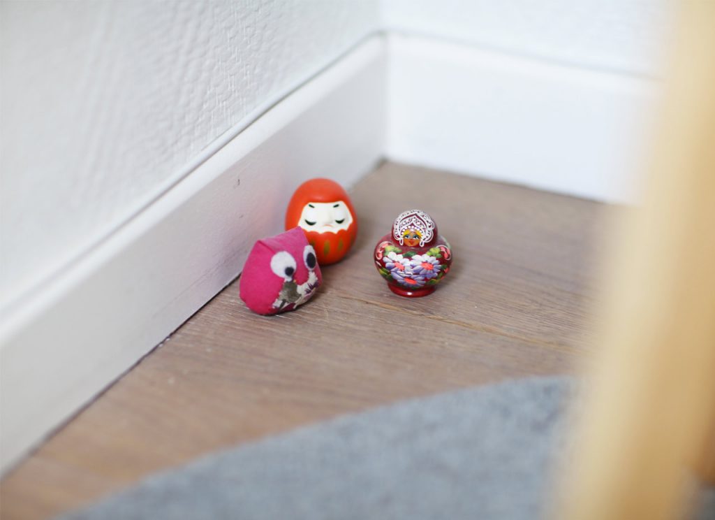 Small figurines: Japanese Daruma Bodhidharma, mini russian puppet and pink owl