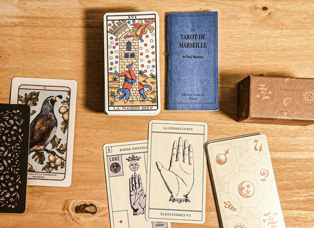 The whisper of woods and fur (Jessica Roux’s forest deck), a curious deck — “le nouveau jeu de la main” — part game, part glimpse, the geometry of palmistry, and the Tarot de Marseille. These decks hold more than answers. They hold touch. Ritual. A small theatre of symbols.