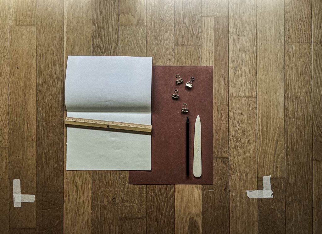 Marking where the thread will bind memory, with ruler and pencil, you map the holes