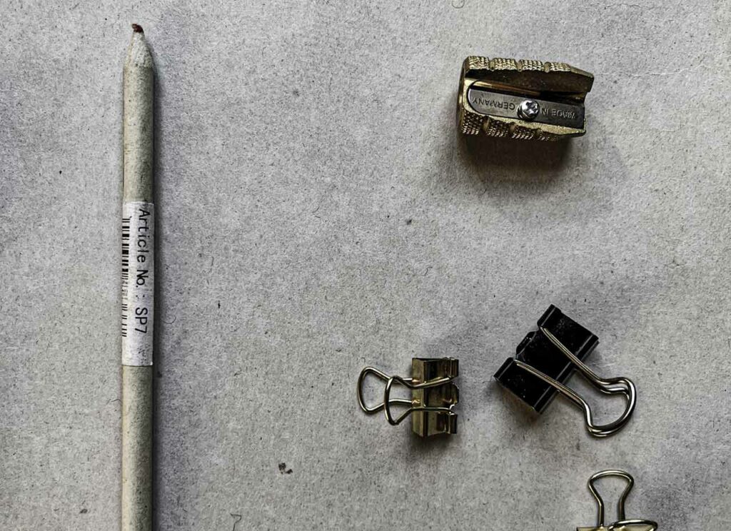 A brass sharpener, some clips used less for holding and more for their strange shapes. Small studio oddities